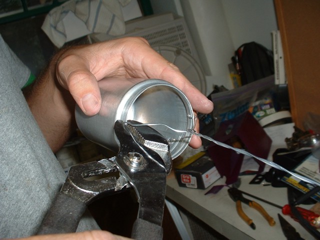 Attaching the anode wire to the drilled holes.