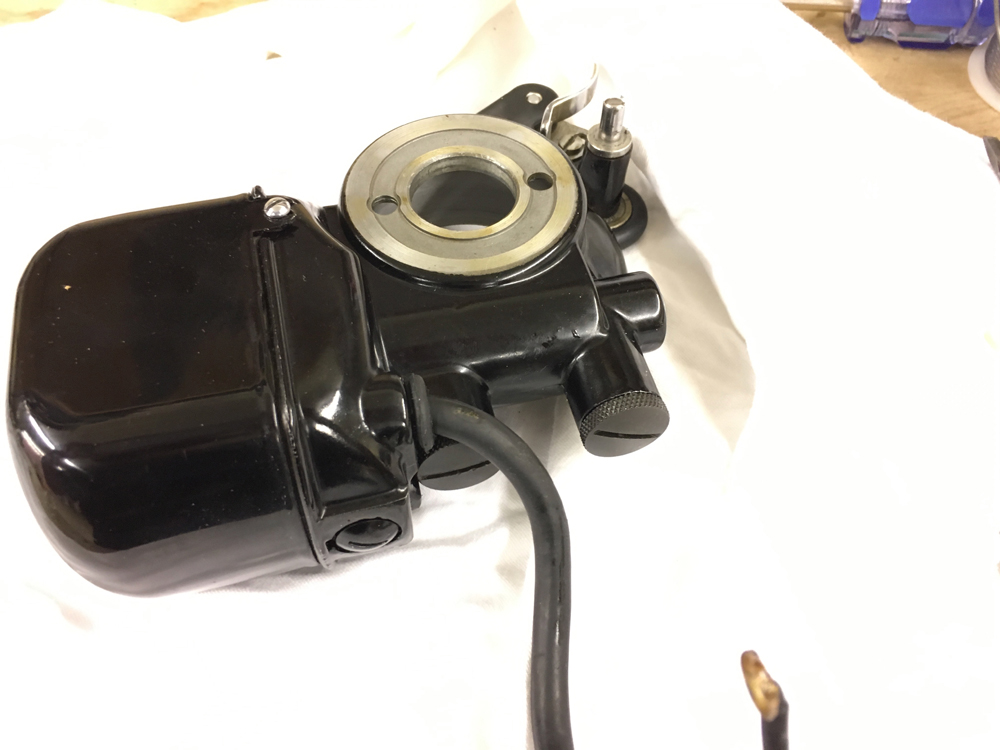 The Singer 201 motor is removed from the machine and the grease access ports are visible.