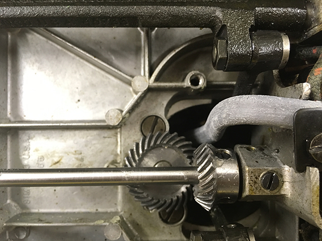 A closeup of the underside machine mechanism, showing the lower helical gears.