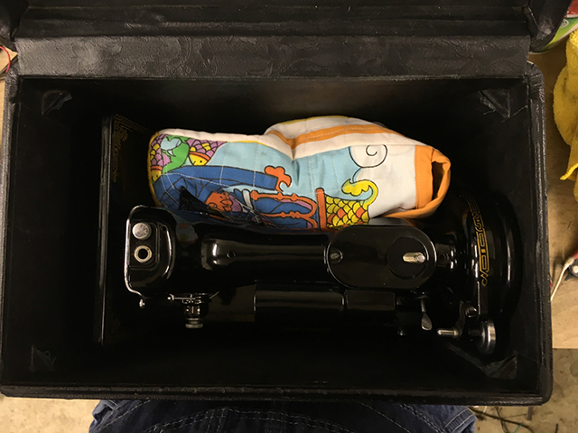 The bag sits lengthwise across the machine resting inside the carrying case.