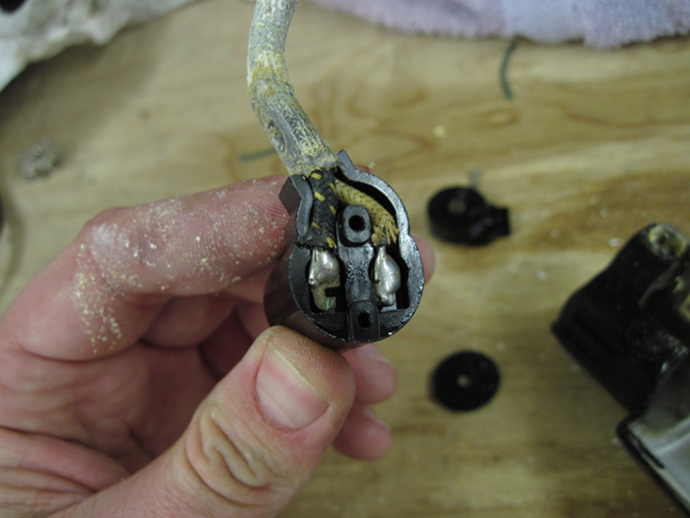 A closeup of the old wiring inside the lampholder.